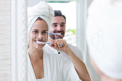 Couple brushing their teeth in the bathroom
