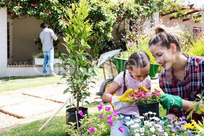 Mother and daughter gardening together in garden