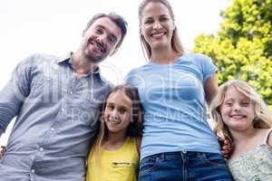 Happy family standing together with arm around