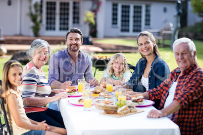 Portrait of happy family having lunch in the garden