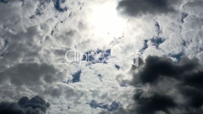 Summer Clouds fly across a royal blue sky.