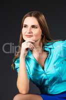 Young business lady in blue isolated on a gray background