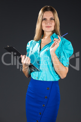 Young business lady in blue isolated on a gray background