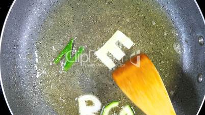 Stir-frying mixed alphabet letters, word Green