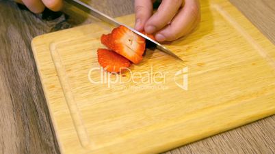 Close Up Female Hands Slicing Fresh Organic Strawberries