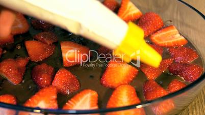 Decorating cake with chocolate spread and fresh strawberry