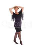 Happy woman in black dress standing.