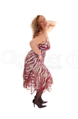 Happy blond woman dancing in summer dress.