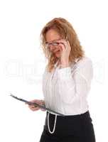 Business woman looking at her clipboard.