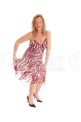 Blond woman dancing in summer dress.