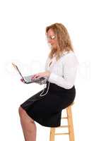 Business woman sitting and working with laptop.