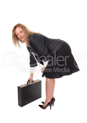 Business woman picking up her briefcase.