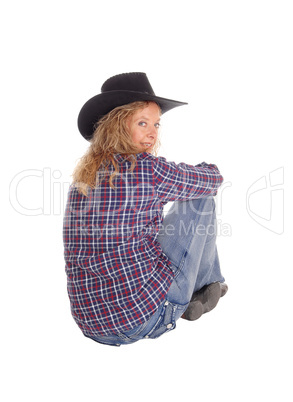 Lovely woman sitting on floor with hat.