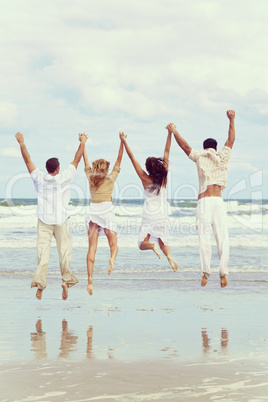 Four Young People Two Couples Jumping in Celebration On Beach