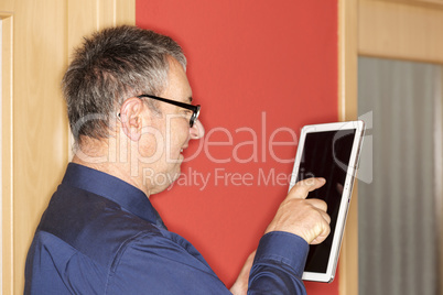 Man with tablet PC on the corridor