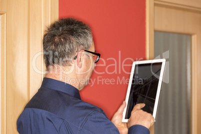 Man with tablet PC on the corridor