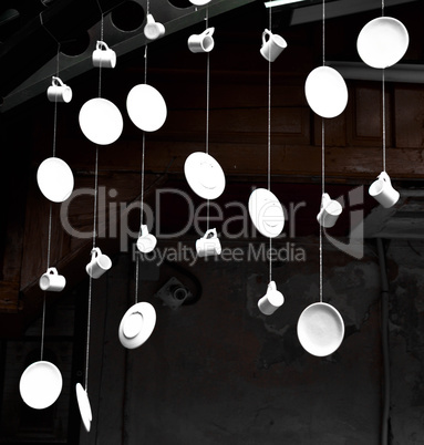 Dishes and cups hanging on the ropes