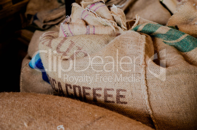 Sack with coffee beans at warehouse
