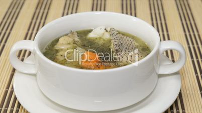 Macrourus fish soup is stirred using a spoon