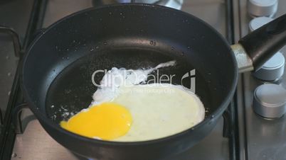 The process of frying eggs in a skillet. Closeup