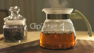 Brewing kipany tea in a glass teapot