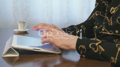 Woman works over documents using a digital tablet