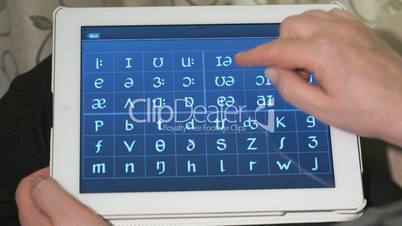 Typing on a virtual keyboard of tablet pc. Closeup
