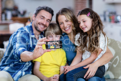 Happy family taking a selfie on mobile phone