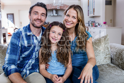 Portrait of happy family sitting on a sofa Portrait of happy family sitting on a sofa