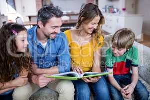 Happy family looking at a photo album