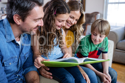 Happy family looking at a photo album