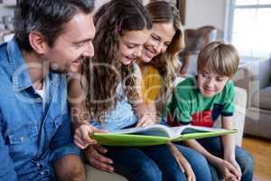 Happy family looking at a photo album