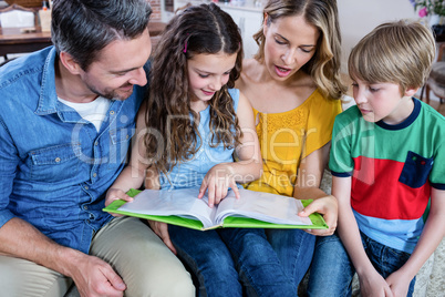 Happy family looking at a photo album