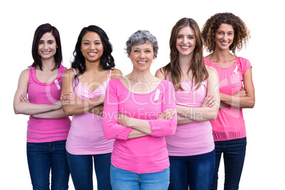 Smiling women in pink outfits posing for breast cancer awareness