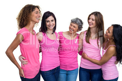 Smiling women in pink outfits posing for breast cancer awareness