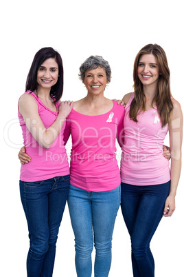 Smiling women in pink outfits posing for breast cancer awareness