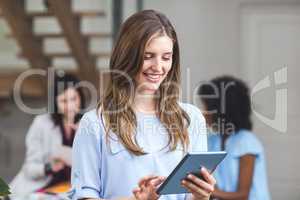 Happy businesswoman using digital tablet