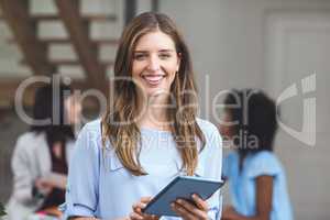 Happy businesswoman using digital tablet