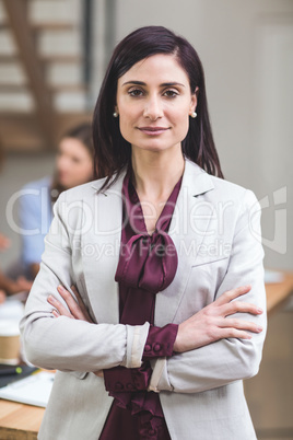 Portrait of businesswoman standing with arms crossed