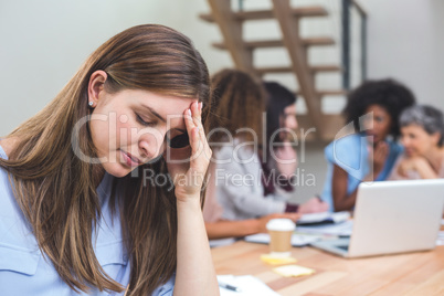 Tense businesswoman sitting in office