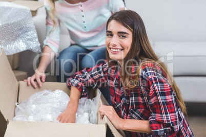 Woman unpacking carton boxes