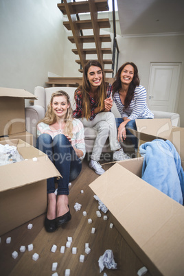 Portrait of friends sitting in their new house