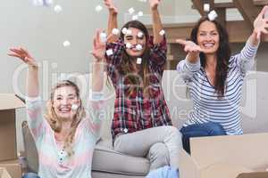 Playful friends playing with packing peanuts