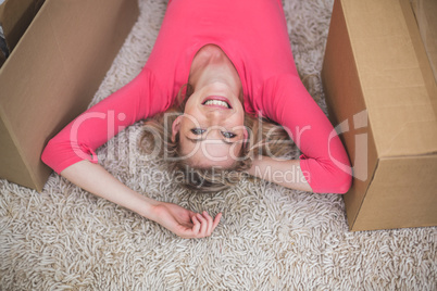 Beautiful woman lying on rug in living room