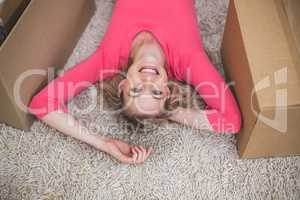 Beautiful woman lying on rug in living room