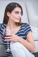 Beautiful woman sitting with a glass of red wine