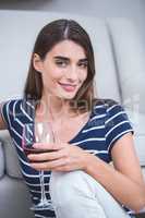 Beautiful woman sitting with a glass of red wine