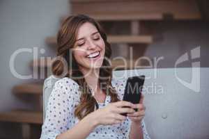 Beautiful woman looking at her mobile phone