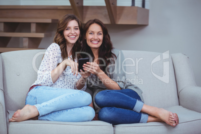 Two beautiful women looking at the mobile phone