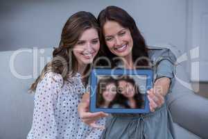 Friends taking a selfie with digital tablet